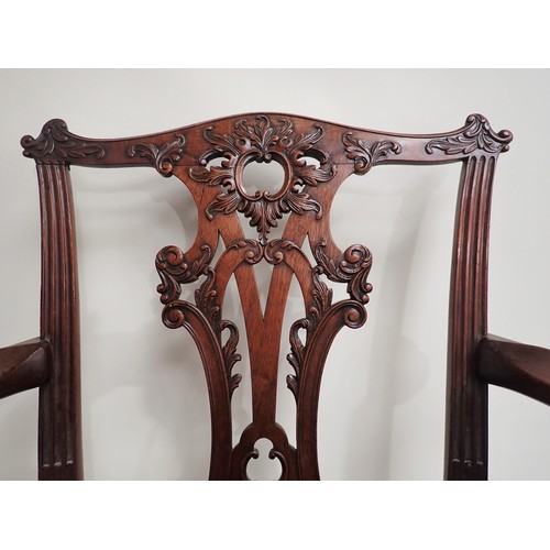 615 - A George III mahogany Elbow Chair in the Chippendale style with leafage carving and leather seat mou... 