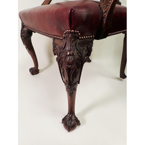 615 - A George III mahogany Elbow Chair in the Chippendale style with leafage carving and leather seat mou... 