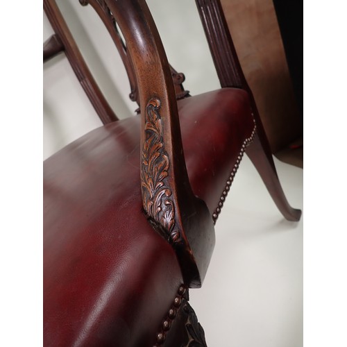 615 - A George III mahogany Elbow Chair in the Chippendale style with leafage carving and leather seat mou... 