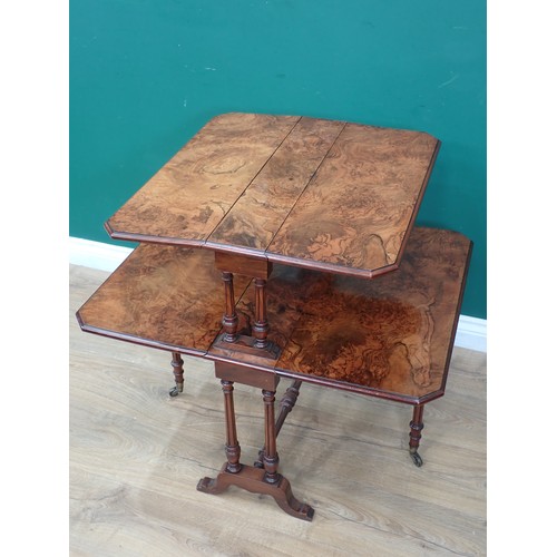 616 - A Victorian figured walnut two tier Sutherland Table mounted on turned supports and square cut feet ... 