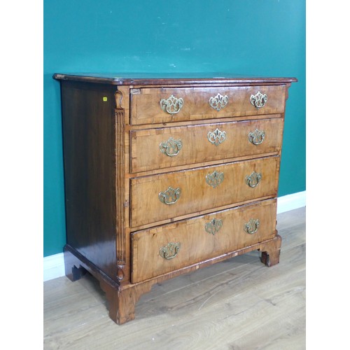 697 - An early Georgian walnut Chest, the moulded top cross-banded in rosewood, with fluted chamfered corn... 