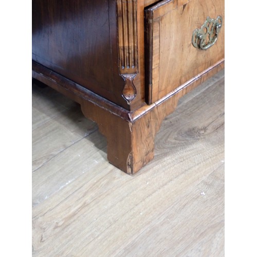 697 - An early Georgian walnut Chest, the moulded top cross-banded in rosewood, with fluted chamfered corn... 