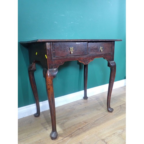 712 - A Georgian oak Lowboy, the moulded top over two drawers with brass drop handles and raised on tapere... 