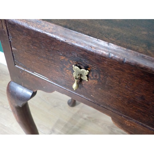 712 - A Georgian oak Lowboy, the moulded top over two drawers with brass drop handles and raised on tapere... 