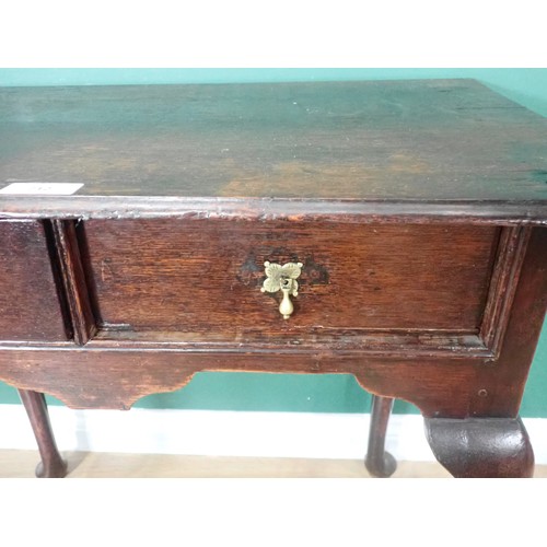 712 - A Georgian oak Lowboy, the moulded top over two drawers with brass drop handles and raised on tapere... 