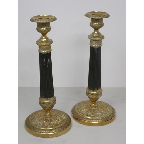 710 - A pair of French brass Candlesticks with reeded stems and circular bases with leafage design 9 1/2in... 