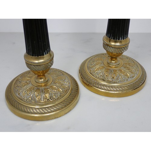 710 - A pair of French brass Candlesticks with reeded stems and circular bases with leafage design 9 1/2in... 