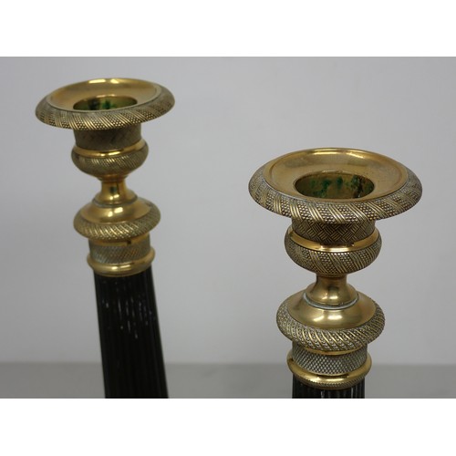 710 - A pair of French brass Candlesticks with reeded stems and circular bases with leafage design 9 1/2in... 