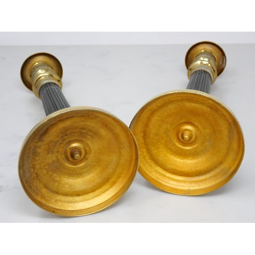 710 - A pair of French brass Candlesticks with reeded stems and circular bases with leafage design 9 1/2in... 