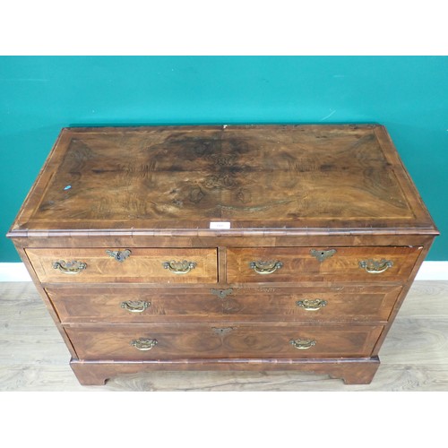 723 - A Georgian walnut Chest with moulded top above two short and three long cross banded and feather ban... 