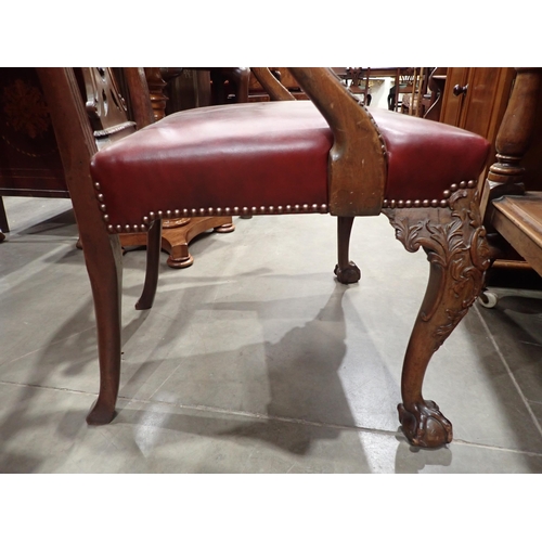 615 - A George III mahogany Elbow Chair in the Chippendale style with leafage carving and leather seat mou... 