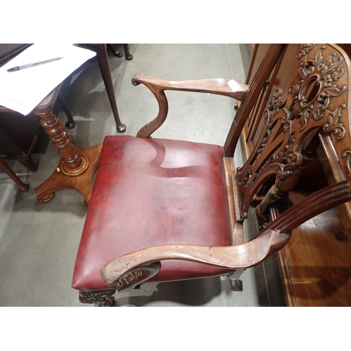 615 - A George III mahogany Elbow Chair in the Chippendale style with leafage carving and leather seat mou... 