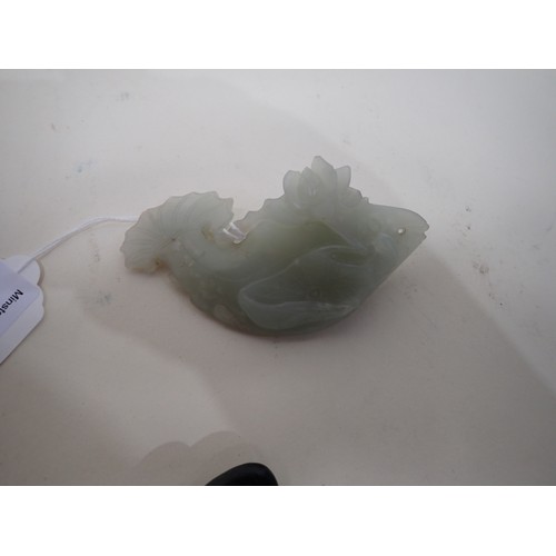 413 - A Chinese celadon Jade carved Fish with lily pad and flower to one side, small chips, on hardwood st... 