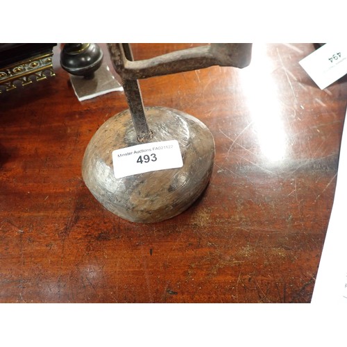 493 - An 18th Century iron Rushlight Holder on domed wooden base, 9in H