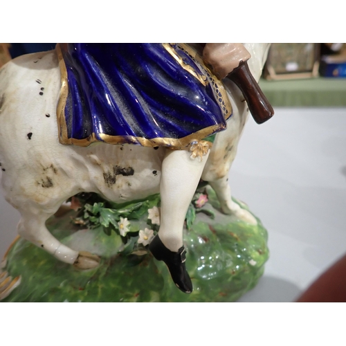 421 - A pair of 19th Century Derby Figures of The Welsh Tailor and his Wife, each figure riding a goat, th... 