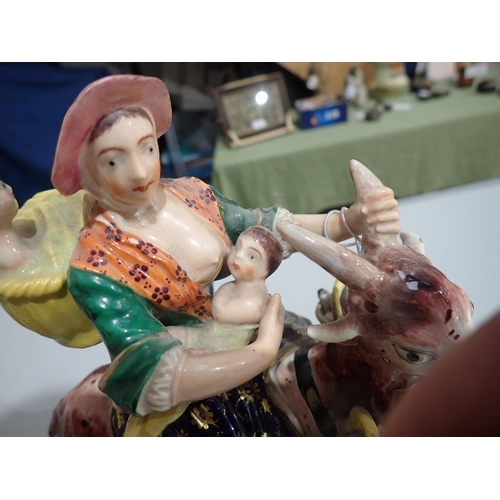 421 - A pair of 19th Century Derby Figures of The Welsh Tailor and his Wife, each figure riding a goat, th... 