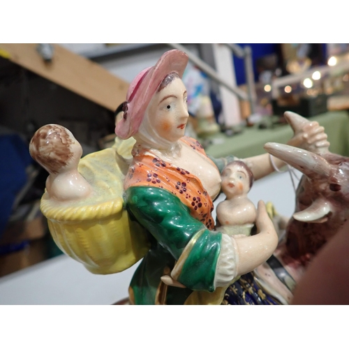 421 - A pair of 19th Century Derby Figures of The Welsh Tailor and his Wife, each figure riding a goat, th... 