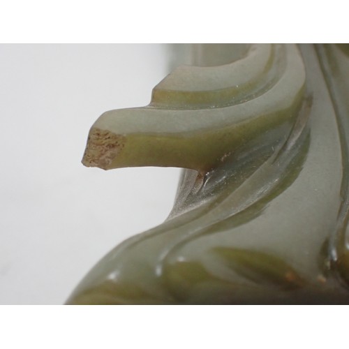 407 - An Oriental carved jade standing figure of Chinese Lady wearing robes having branch and leaf applied... 