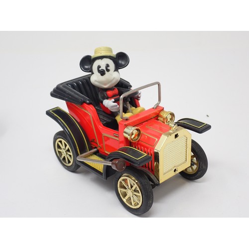 62 - A Japanese tinplate Mickey Mouse Car, a Japanese tinplate Car and a Schuco Ford T Coupe