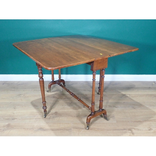 12 - A Victorian walnut Sutherland Table on turned supports and casters, 3ft W