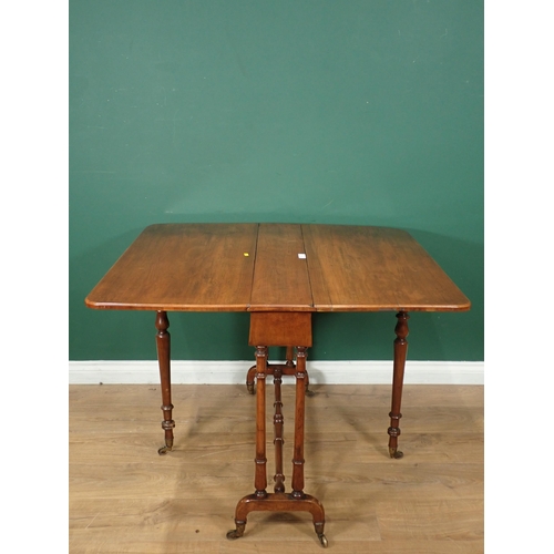 12 - A Victorian walnut Sutherland Table on turned supports and casters, 3ft W