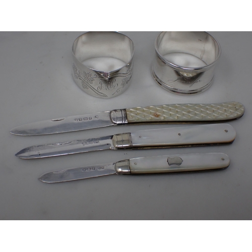 145 - A Victorian Fruit Knife with folding silver blade, Sheffield 1860, two others and two silver Napkin ... 