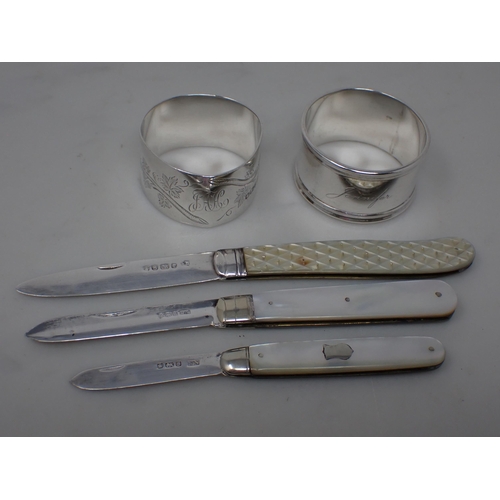 145 - A Victorian Fruit Knife with folding silver blade, Sheffield 1860, two others and two silver Napkin ... 