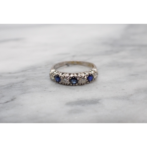 160 - A Sapphire and Diamond half Eternity Ring pavé-set three round sapphires interspersed with brilliant... 