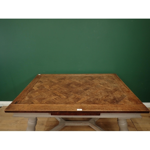 19 - A French oak parquetry top Table with painted and turned splayed legs, 4ft 6in 3ft 1in