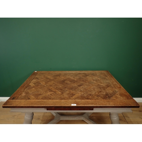 19 - A French oak parquetry top Table with painted and turned splayed legs, 4ft 6in 3ft 1in