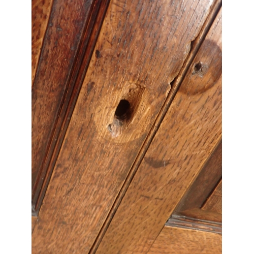 2 - An antique oak Court Cupboard, the upper section having three cupid's bow panelled doors, the centra... 