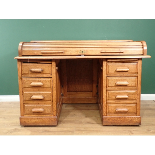 20 - An oak tambour fronted Desk fitted eight drawers (tambour front split) 4ft 5in W x 3ft H