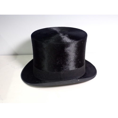 259 - A black Dunn & Co silk Top Hat in fitted box Internal circumfrance approx 21in.

7 1/2 x 6 inches in... 