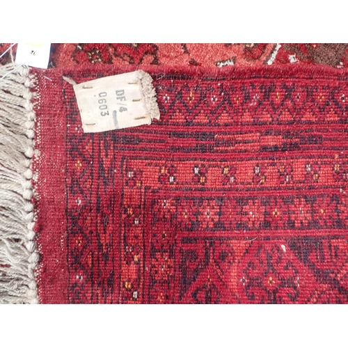 26 - A Persian multi-bordered Rug with three central medallions, predominantly red, 6ft 6in x 4ft 4in