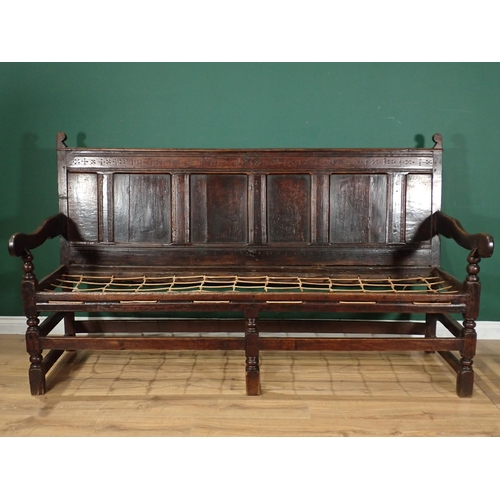 29 - A Late 17th Century oak Settle with panel back with punch work decoration on turned supports, 6ft 3