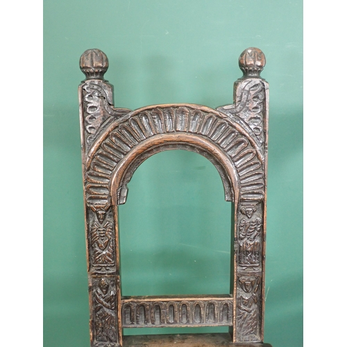 305 - A pair of carved oak Chairs with arched backs carved figures on turned supports