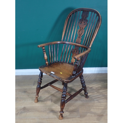 313 - An antique ash and elm spindle back Windsor Chair on turned supports and H stretcher.