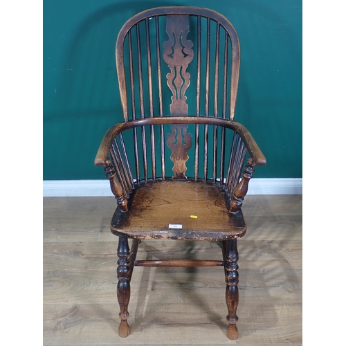 313 - An antique ash and elm spindle back Windsor Chair on turned supports and H stretcher.