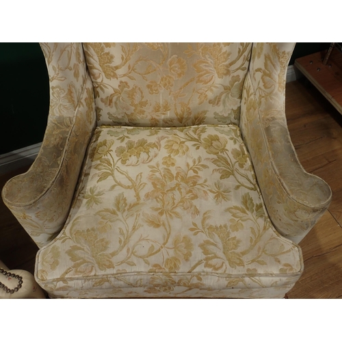 318 - A floral upholstered Wing Back Armchair on carved front supports and a cream Wing Back Armchair with... 