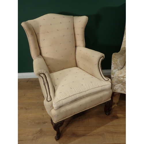 318 - A floral upholstered Wing Back Armchair on carved front supports and a cream Wing Back Armchair with... 