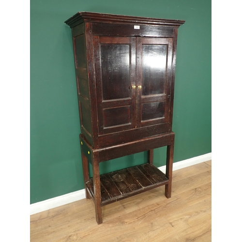 319 - An antique oak Cupboard on Stand fitted a pair of panelled doors, the base with lower shelf,  5ft 6i... 