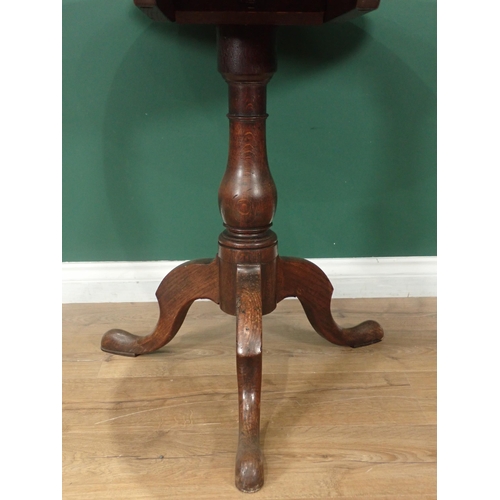 323 - An circular oak tilt top Tripod Table on turned column and splayed supports, 2ft 5