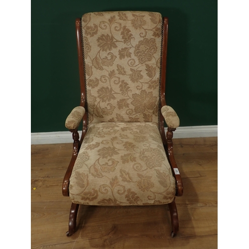 343 - A cream and floral upholstered Rocking Chair