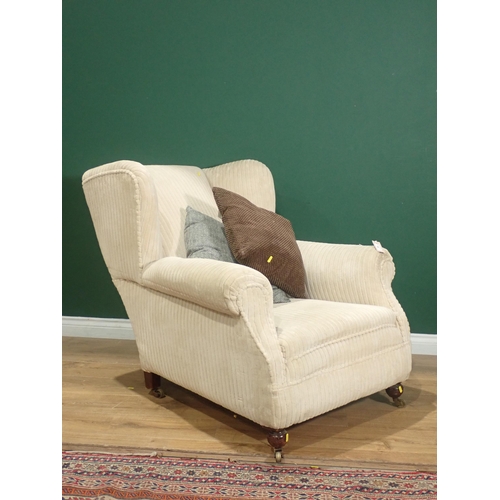 362 - An upholstered Armchair with turned front supports and casters