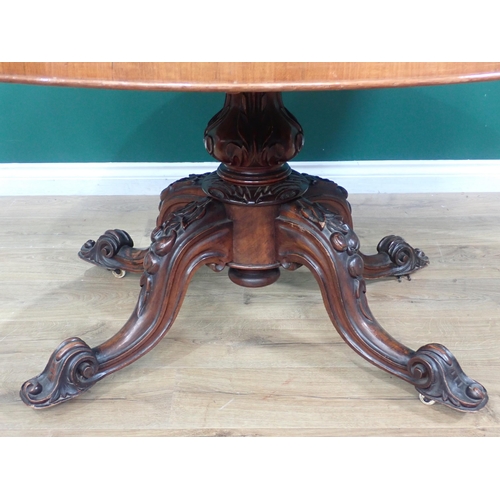 395 - A Victorian walnut Breakfast Table with moulded oval top on carved column and quadruple base, 4ft 8i... 