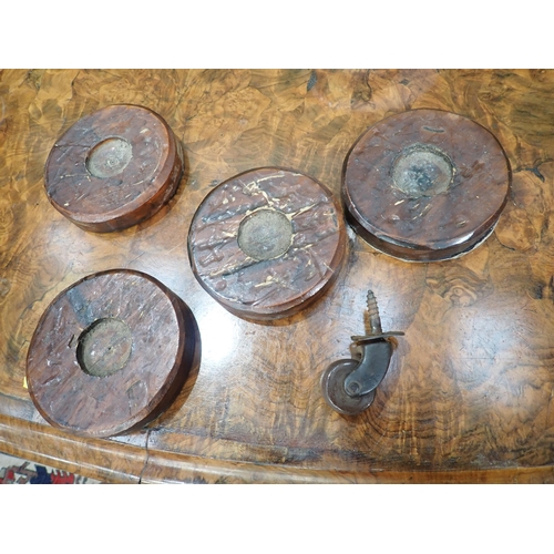 395 - A Victorian walnut Breakfast Table with moulded oval top on carved column and quadruple base, 4ft 8i... 