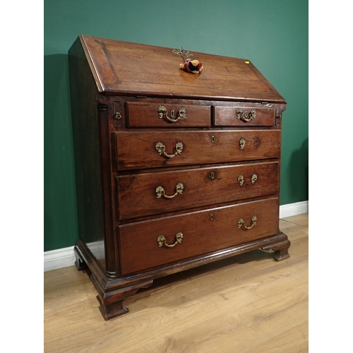 398 - A 19th Century mahogany Bureau the fall down above two short and three long drawers on ogee bracket ... 