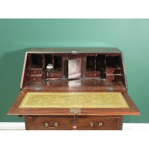 398 - A 19th Century mahogany Bureau the fall down above two short and three long drawers on ogee bracket ... 