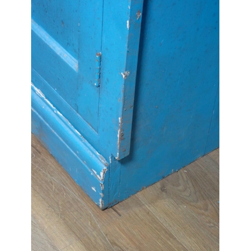 399 - A blue painted Cupboard with a pair of panelled doors enclosing shelves, above another pair of panel... 