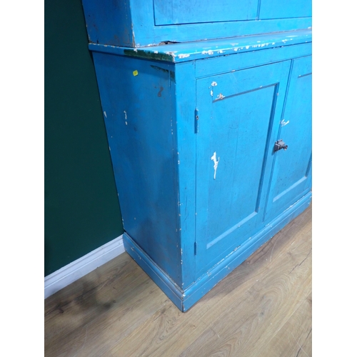 399 - A blue painted Cupboard with a pair of panelled doors enclosing shelves, above another pair of panel... 